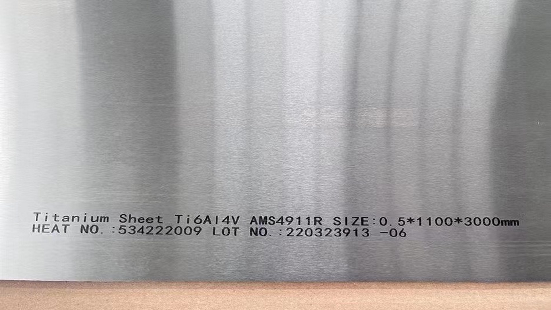 Marked titanium sheet for heat and lot traceability through processing
