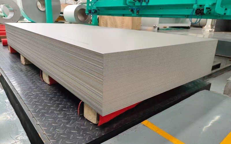 Titanium plate material overview with stacked sheets in the workshop