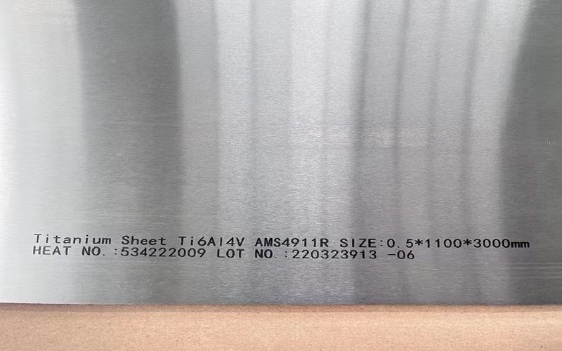 Marked titanium sheet surface showing material specification details