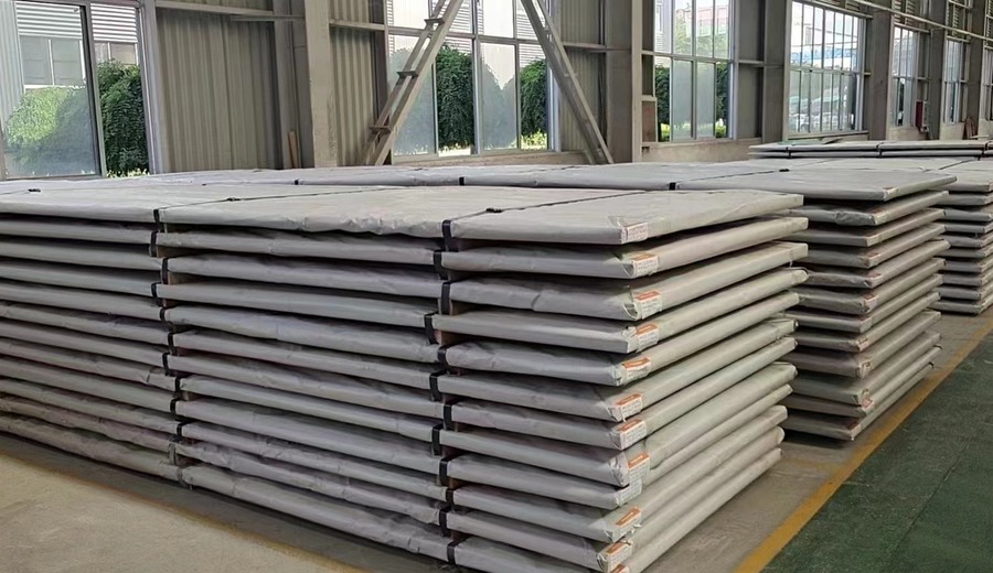 Stacked stainless steel plates inside TiAlloy production plant for mill-direct supply