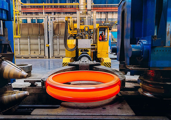 Hot titanium seamless ring rolling and route specific forging